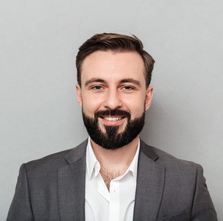 close-up-portrait-young-bearded-man-white-shirt-jacket-posing-camera-with-broad-smile-isolated-gray